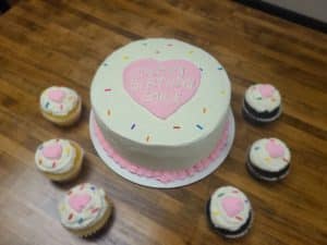 heart birthday cake with matching cupcakes