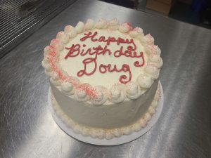 white birthday cake with pink sugar